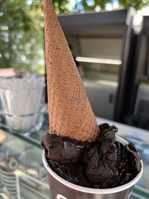 Chocolate/raspberry gelato with cone on top  at Kavarna Cacao in Ljubljana