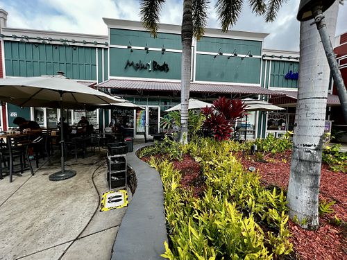 Outdoor seating with umbrellas  at Moku Roots in Kula