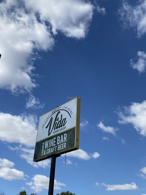 Outside signage with fluffy clouds at Vida Vegan  at Vida Eatery  in Bakersfield