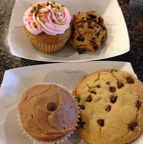 a pistachio rosewater cupcake, a breakfast cookie, a banana chocolate chip cupcake and a chocolate chip cookie  at Charlotte's Bakery in Fresno
