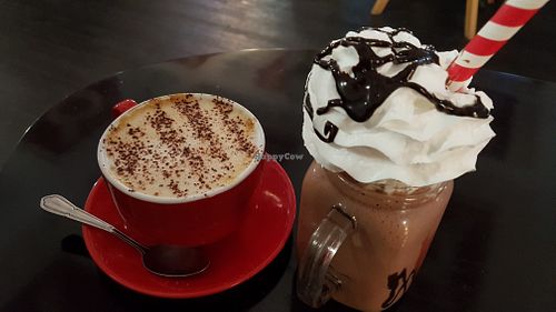Oat latte and my mega chocolate strawberry smooth loaded with Cream.  at Prana Cafe in Leicester