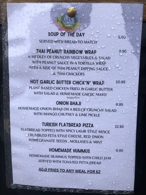 Menu as of July 2024 (seen from outside on a rainy summer day!) at Karmic Cakery in Berwick-upon-tweed