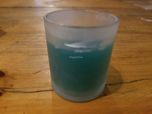 Freshly pressed juice shot with spirulina at El Vegano Cocina in Rosarito