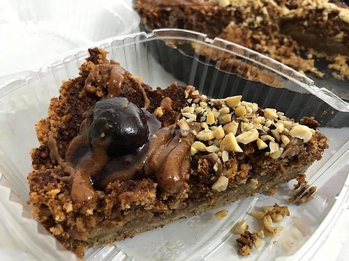 Gluten free Apple Crumble Pie topped with a caramel sauce and a fresh cherry on top. at Frescura PR in Catano