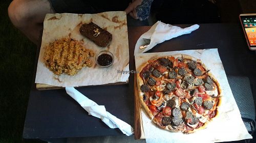 Pizza and seitan steak at Veganga in Moscow
