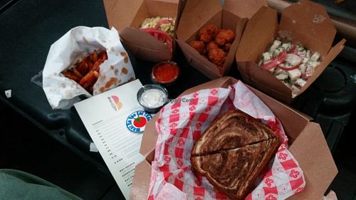 Ruben, Spicy Fries and side platter with potato salad, coleslaw and beer battered cauli bites from Beaut Burger at Beaut Burger in Tucson