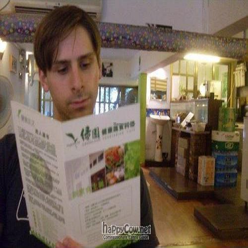 Perusing the menu at Greenland at Greenland Vegetarian Cafe in Guangzhou