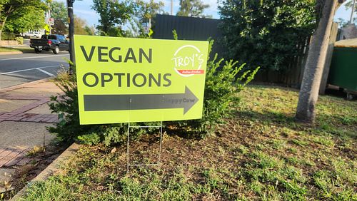 Sign out front announcing vegan options at Troy's Italian Kitchen in Arlington