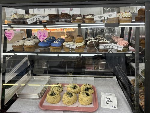 Display case of cupcakes and vegan cheese rolls   at Cake Girl in Los Angeles