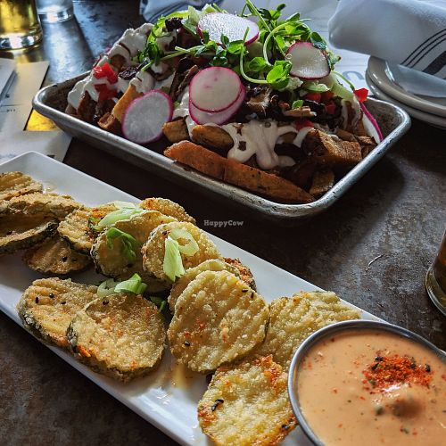 Fried pickles and loaded fries with shiitake bacon at ERIS Brewery and Cider House in Chicago