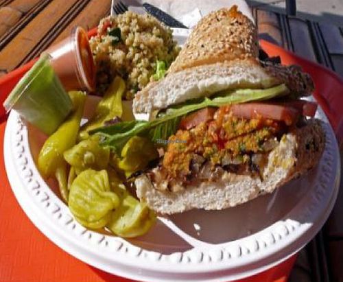 Healthyca sausage: homemade vegan sausage on sesame roll with tomato, lettuce, grilled onion, tofu pesto and red pepper sauces at HealthyCA in North Hollywood