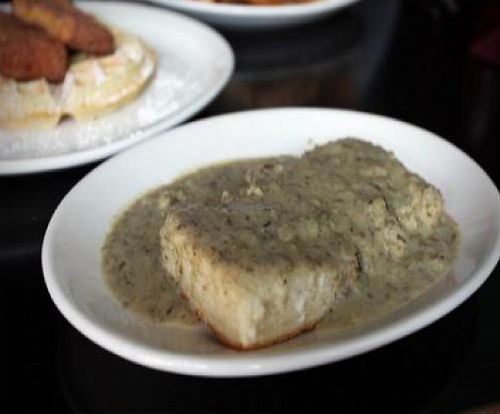 homemade biscuit and gravy: huge serving of homestyle biscuits covered in thick mushroom and veggie sausage gravy at Hungry Tiger in Portland