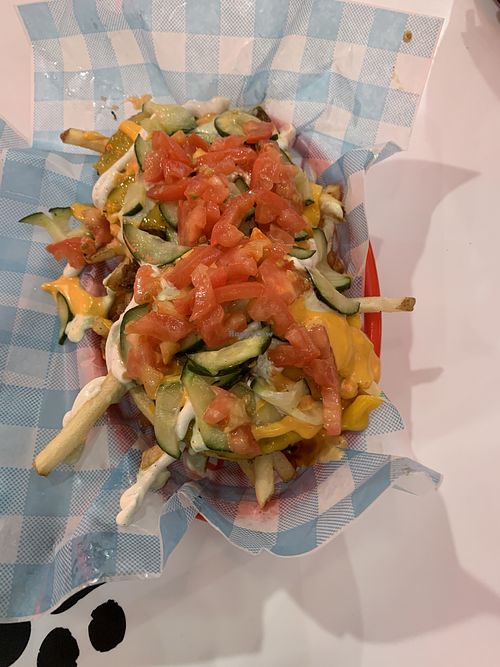 Dogpile fries topped with tomatoes and pickles  at Monty's Good Burger in Riverside