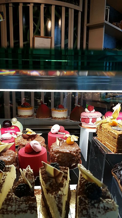 The round cake behind everything, with 3 layers (yellow, pink, white) is also vegan, mango flavoured at RIX - AsparaGoose in Marupe