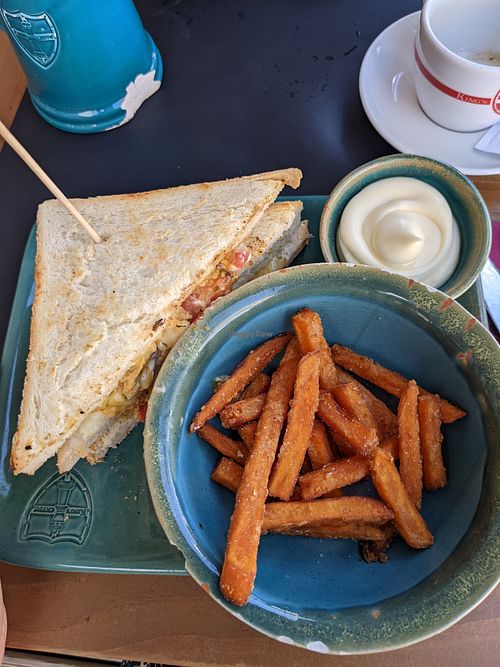 Vegan tripleta (club sandwich) with vegan cheese, soy medaillons, mayonaise, tomato, lettuce, and sweet potato fries on the side at King's Caffe in Malinska