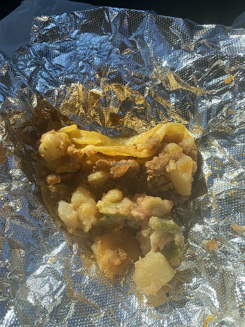 Street taco (no toppings) papa con chorizo 😋 messy but good (remnants of papa con nopales)  at Borreguitas in Pomona