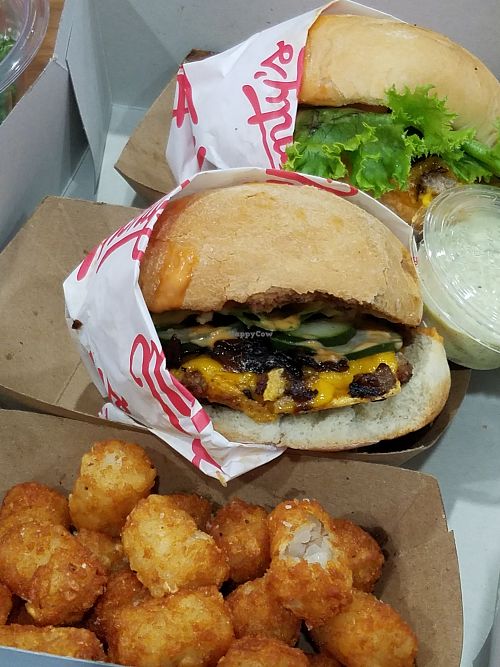 Two single burgers and tatertots at Monty's Good Burger - Koreatown in Los Angeles