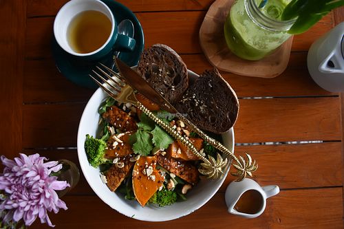 Buddha bowl with rye bread  at Kin Cafe in Seminyak