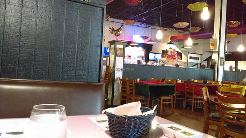 Decor includes umbrellas hanging from ceiling. Industrial, yet modern and artsy. at Holi in Dothan