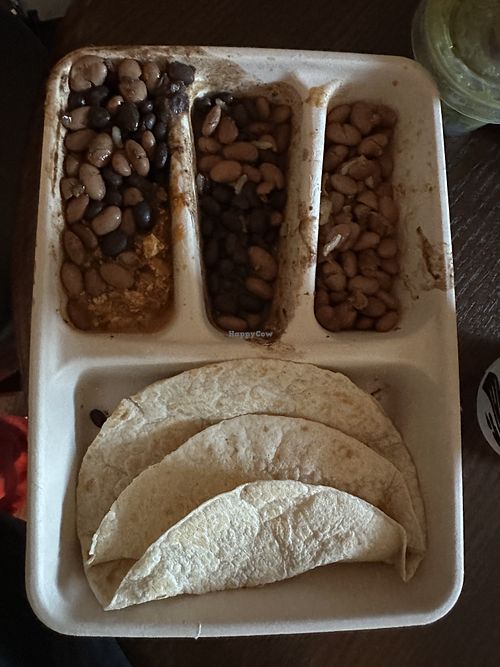 Kids meal (comes with chips and a drink) got the sofritas, black beans, pinto beans, and a side of guac (for a charge).   at Chipotle in Lake Grove