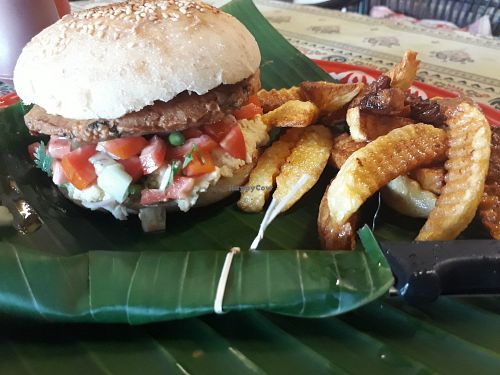 Chickpea burger patty with hummus in vegan bun with chips at Yoddoi Coffee & Tea in Chiang Rai