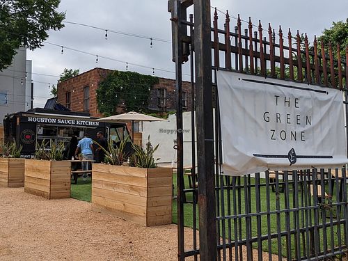 Spacious outdoor picnic table seating in g The Green Zone at Houston Sauce Co in Houston