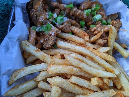 Sauced chick'n fried 'shrooms basket well seasoned lightly battered fried mushrooms with scallions, remoulade and cheese sauces with fries. at Houston Sauce Co in Houston