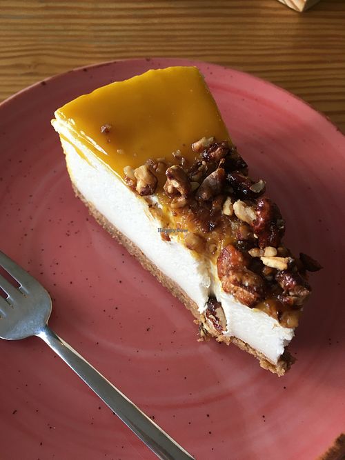 Cheesecake made with vegan feta, topped with passion fruit coulis and caramelized nuts at Orteá - Vegan Collective in Lisbon