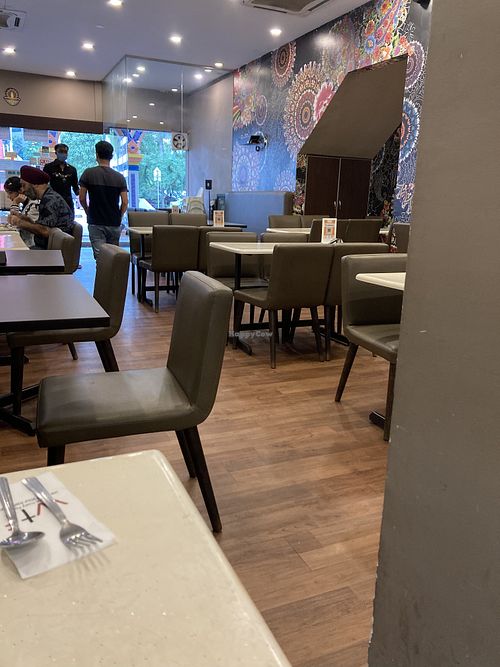 Comfortable seating on busy street  at Mr Naan & Mrs Idly in Kuala Lumpur