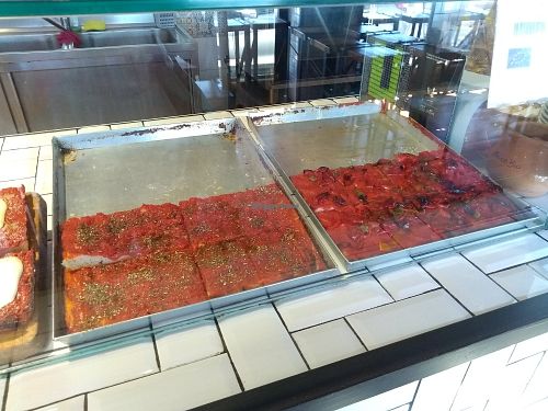 Focaccia they sell for 2 euros (the two are vegan: one plain with tomato sauce and the other one with peppers) at Amico Bio Mergellina in Naples