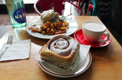 Cinnamon roll, seitan biscuits and gravy, and potatoes. Spicy chai on the side.  at Sweetpea Baking Company in Portland