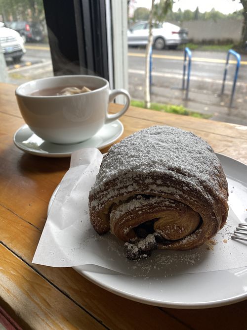 Pain au chocolat and Hot Tea on a Rainy Morning 😌  at Sweetpea Baking Company in Portland
