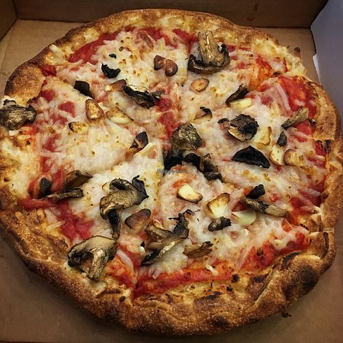 Pizza with vegan cheese, mushrooms and fresh garlic. 10‘‘ for 11 USD.  at G's Pizza - Howard Ave in New Orleans