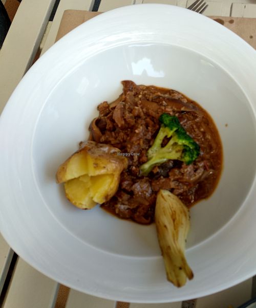 Ragout of seitan and mushrooms served to a potatoes, onion, and broccoli.  at Sa Garrofa in Begur