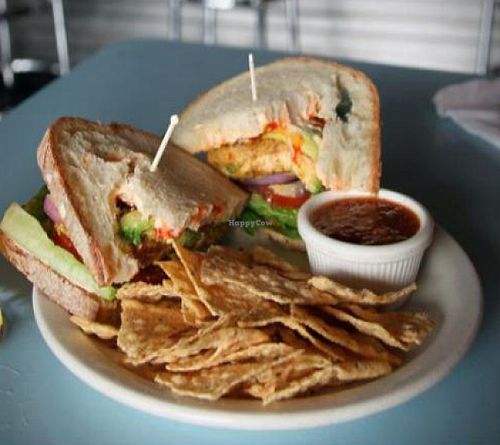 weeping tiger sandwich: braised tofu cutlets, avocado, lettuce, tomato, onion, jalapenos, rooster sauce. choice of one side at The Bye and Bye in Portland
