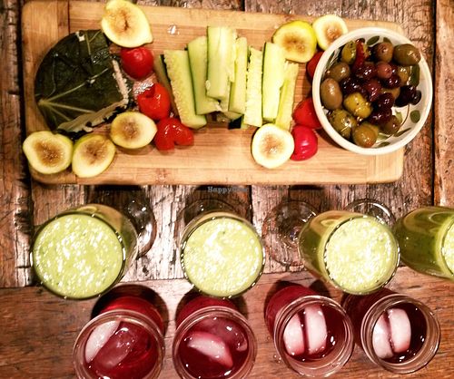 Vegan antipasti plate. Raw veggies, figs, olives and miyoko's cashew cheese wrapped in wine-cured fig leaves.   Served with green smoothies and sugar-free hibiscus iced teas. at The Bel Air Treehouse in Los Angeles
