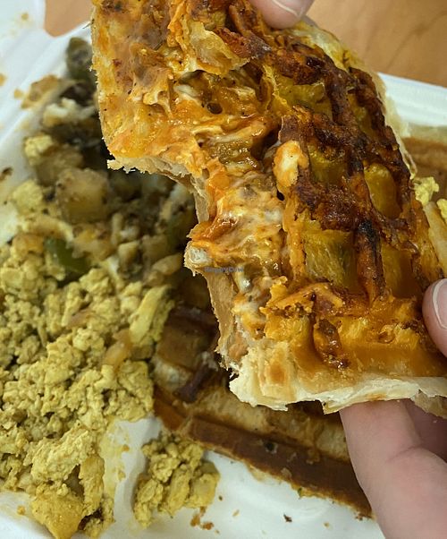 Sausage pizza stuffed waffle, scramble and potatoes on the side at The Greener Kitchen in Baltimore