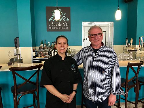 Elena the delightful owner with my happy husband.  at L'Eau de Vie in Baltimore