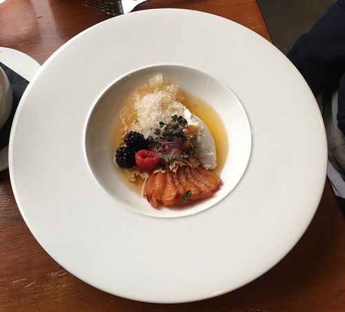 Dessert "soup" with poached peaches, berries and tart syrup at The Juniper Bistro in Banff
