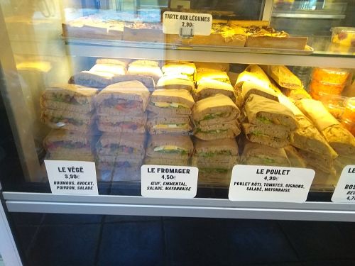 Prices , vgan organic sandwich is the one on the left at Les Frères Chapelier - Boulangerie Artisanale Bio in Toulouse