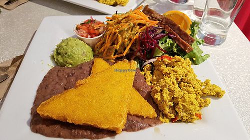 Weekend brunch with polenta, guacamole, black beans, scrambled tofu, tempeh bacon and salad at Aux Vivres - St Laurent in Montreal