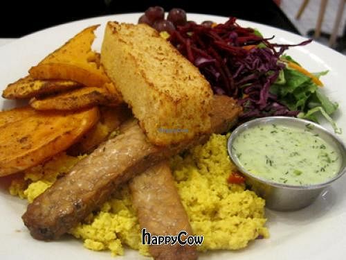 Brunch Le Complet : tofu scramble, tempeh bacon, cornbread, fresh fruit, salad and sweet potatoes. at Aux Vivres - St Laurent in Montreal