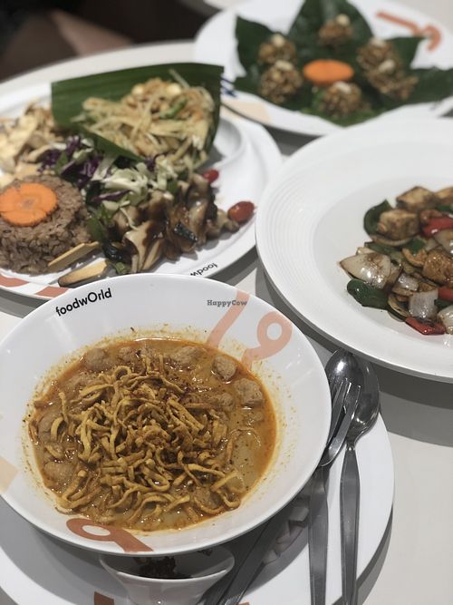 Vegan khao soi, mushroom skewers with rice and som tum, lemongrass salad, stir fry tofu and cashew at Khun Churn - Centralworld in Bangkok