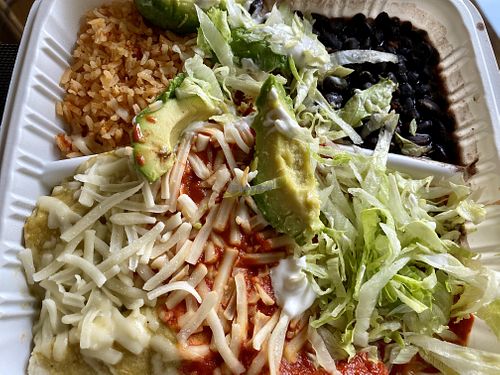 Enchiladas smothered in red and green sauce with all the fixings.  We chose seitan and we chose well! at Ole Ole Burrito Express in Oakland