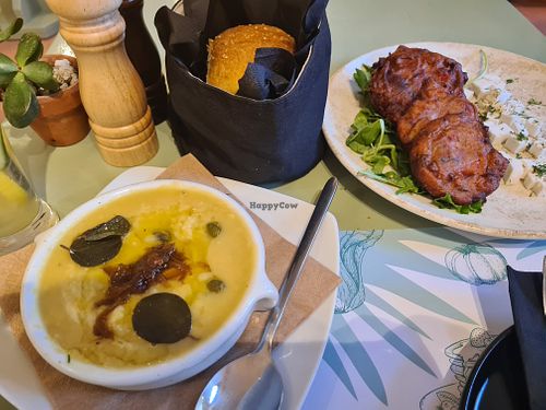 I ate the tomato keftedes and fava bean dip with their rosemary bread. All so tasty and rich in flavour. The outdoor courtyard is cute but the indoor cave bar is so chic.  at Karma in Santorini