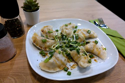 Vegan dumplings with lentils nad cranberries feeling. Topped with sprouts and butter based on soy sauce.  at Vegan Heaven in Lublin