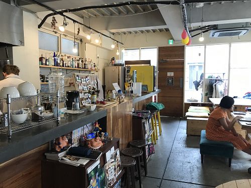 Bar and kitchen + tables where meals are eaten! at Guesthouse Fete in Tokyo