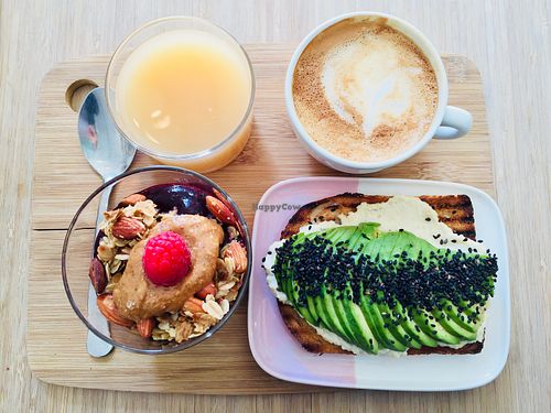 Oatmilk cappuchino, apple-ginger juice, avo toast with vegan cashew cream cheese, chia pudding at Kuuma in Helsinki