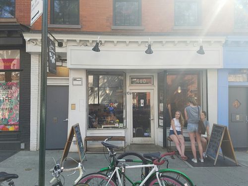 outside with HappyCow Sticker in Window at Sun in Bloom in Brooklyn