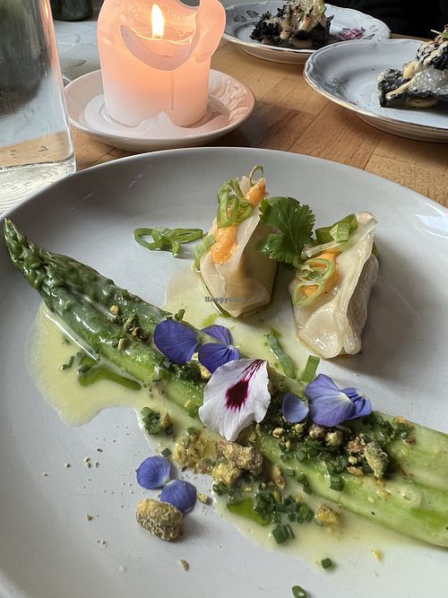 Asparagus, hollandaise, pistachio. Winter kimchi gyozas, fermented chilies.   at Magu in Helsinki